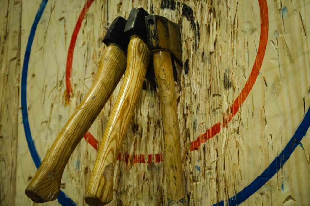 Axe stick into the wood bull's eye in throwing axe sport