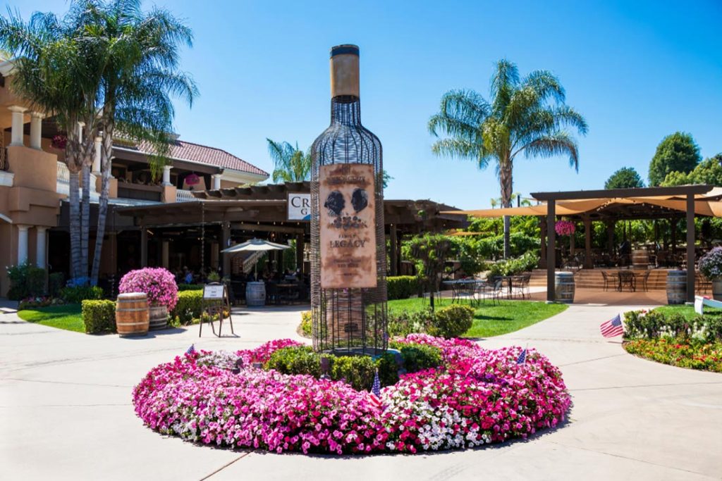 Things to do in Temecula: Wilson Creek Winery in California. Landscape garden with a bottle of wine.