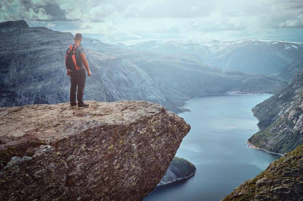 Standing in the trolltunga and enjoys the beautiful view of the norwegian fjord